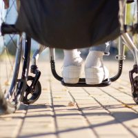 Person of unrecognizable gender and age in wheelchair outside