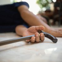 Senior man falling down at home because stumbled on a door