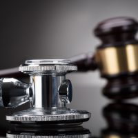 Close-up Of A Stethoscope In Front Of Gavel