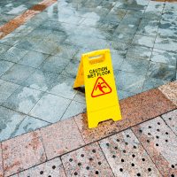 Yellow wet floor warning sign on the floor.